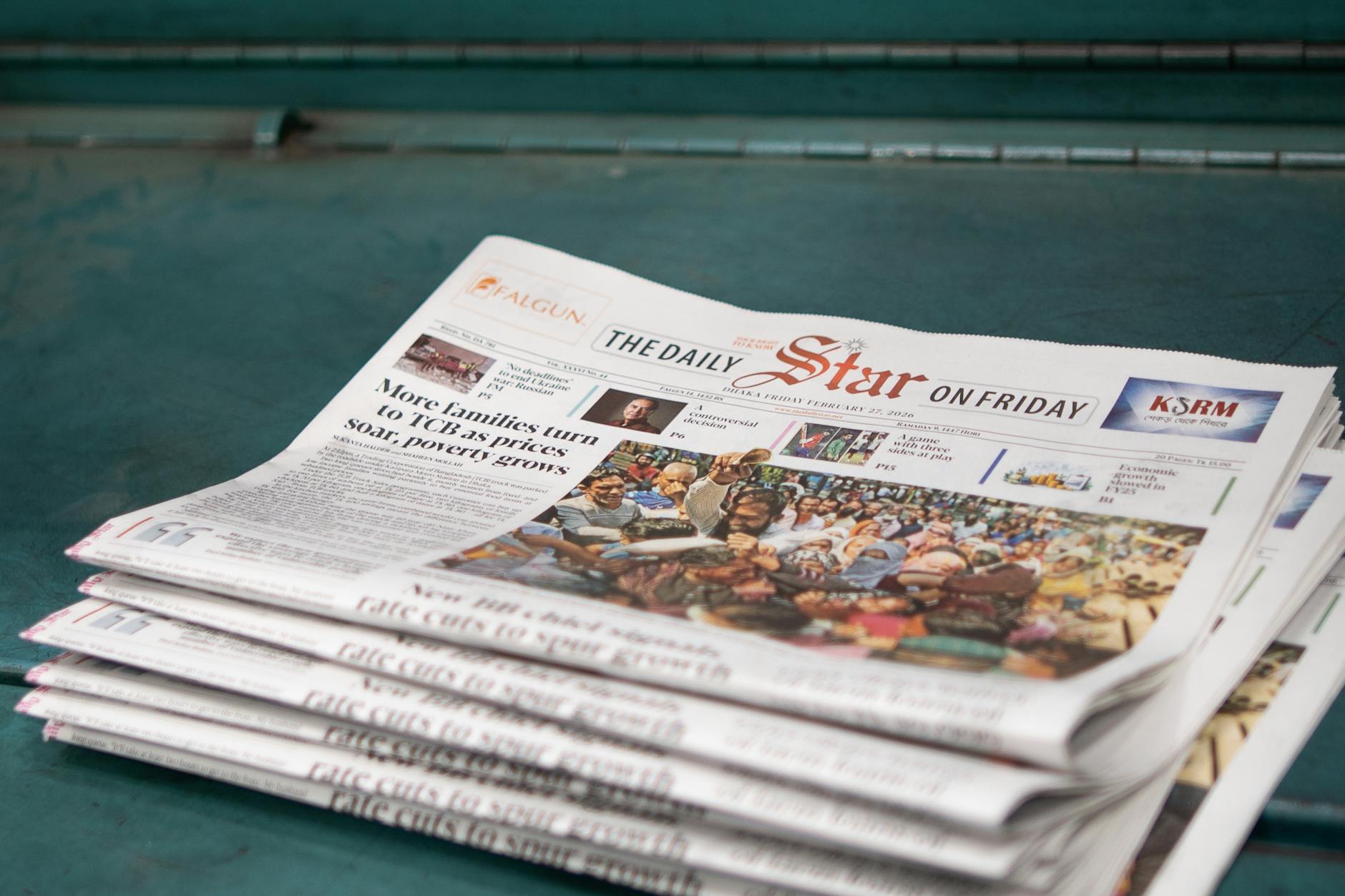 stack of newspapers with headline on poverty